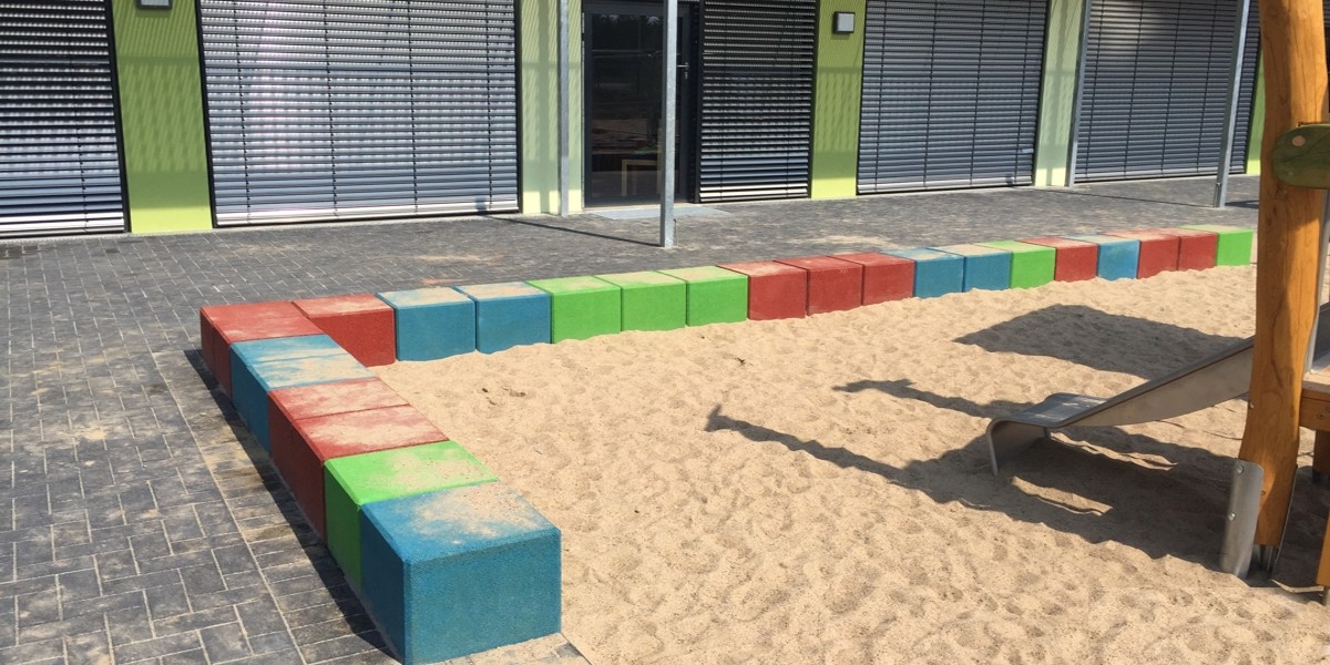 Rubber cubes in blue, green and red in the sandpit